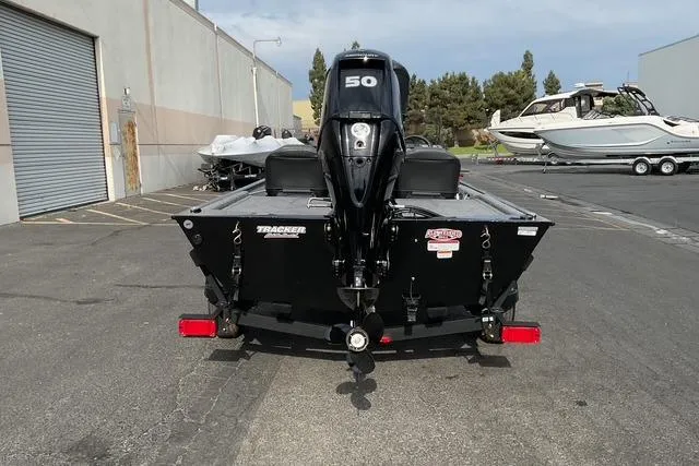 Slide: The Image of 2026 Tracker Bass Tracker Classic XL boat with 50 HP motor, parked outdoors. - 4