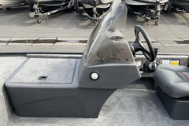 Slide: The Image of 2026 Tracker Bass Tracker Classic XL boat interior with steering console and seating. - 9