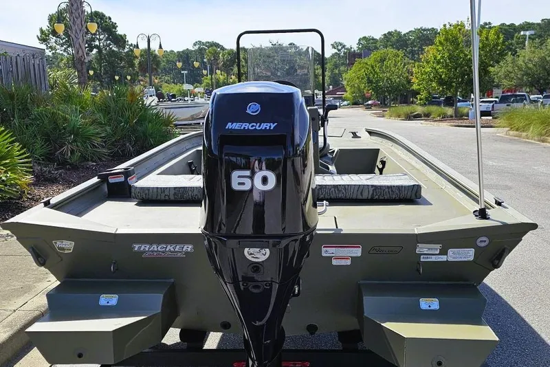 Slide: The Image of 2026 Tracker Grizzly 1860 CC boat with Mercury 60 engine, parked outdoors. - 4