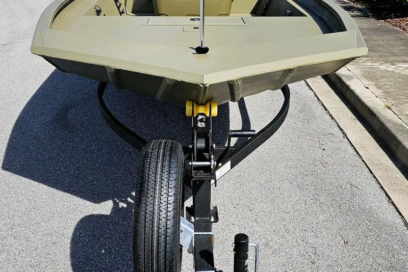 Slide: The Image of 2026 Tracker Grizzly 1860 CC boat on trailer, parked on a street. - 5