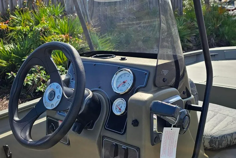 Slide: The Image of Steering console of 2026 Tracker Grizzly 1860 CC boat with gauges and controls. - 8