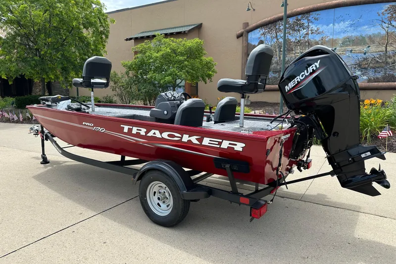 Slide: The Image of 2026 Tracker Pro 170 boat with Mercury engine, parked outdoors. - 2