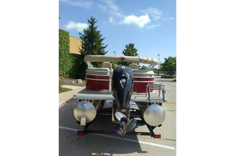 Slide: The Image of 2025 Sun Tracker Party Barge 24 DLX pontoon boat with outboard motor in parking lot. - 5