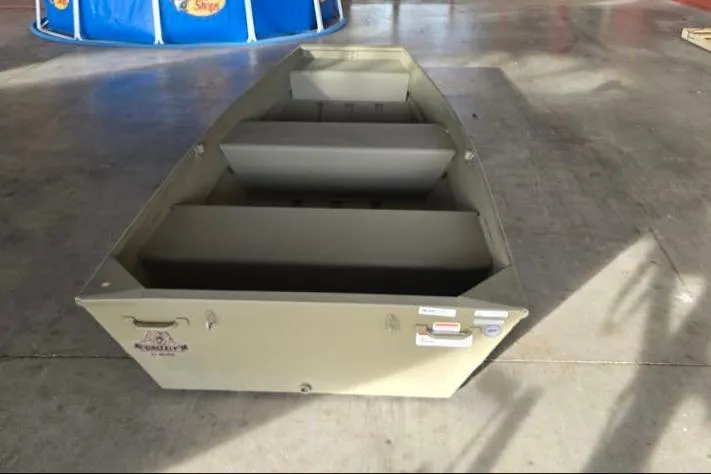 Slide: The Image of 2026 Tracker Grizzly 12 Jon boat in a garage setting. - 3