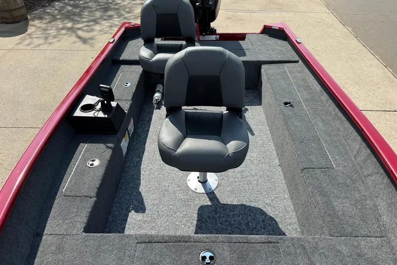 Slide: The Image of 2025 Tracker Super Guide V-16 T boat interior with gray seating and red trim. - 5
