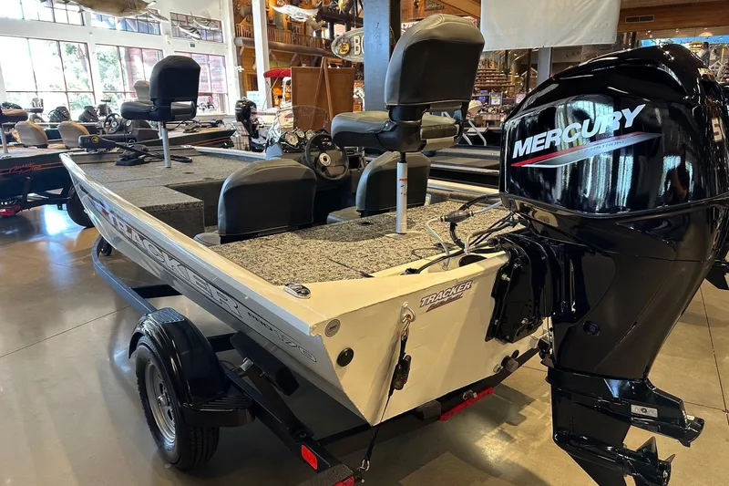 Slide: The Image of 2026 Tracker Pro 170 boat with Mercury engine displayed indoors. - 2