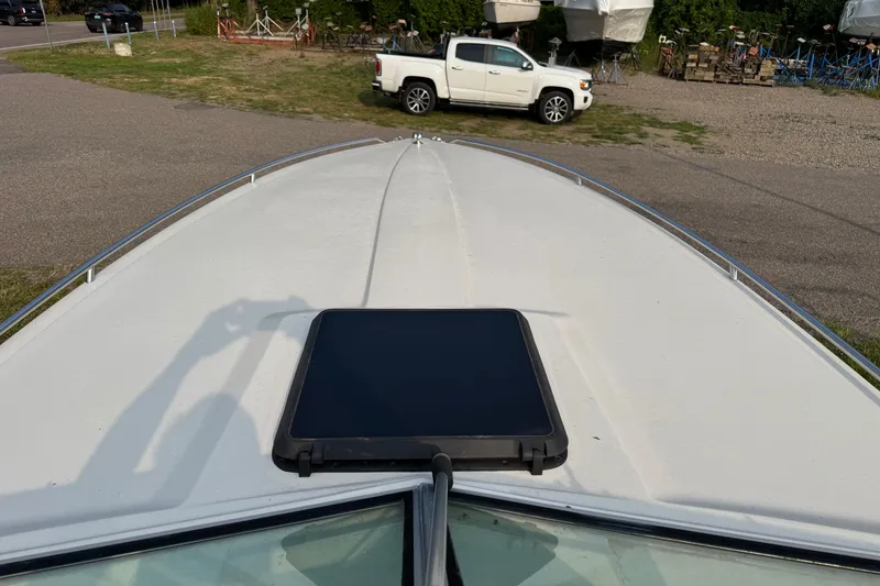 Slide: The Image of 1984 Formula 272 boat deck with a solar panel, parked near a white truck. - 6