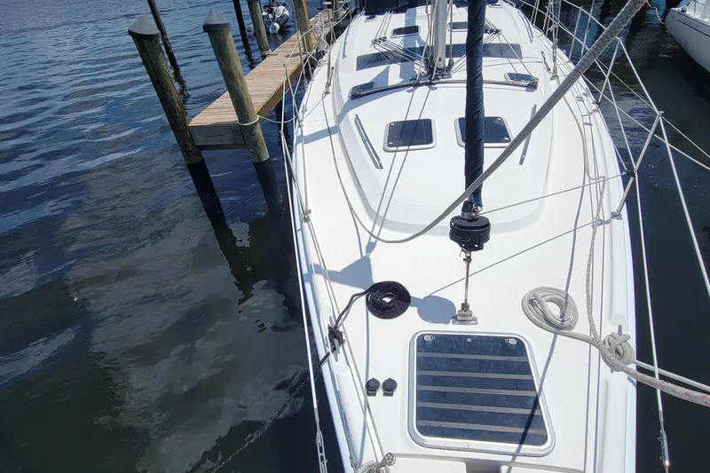 Slide: The Image of 2009 Hunter 49 sailboat docked, showcasing deck and rigging details. - 13