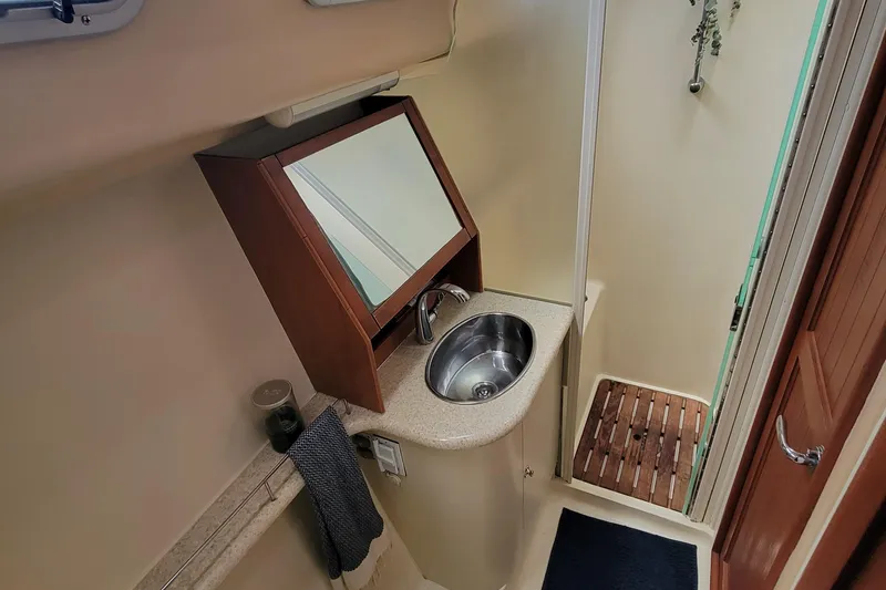 Slide: The Image of 2009 Hunter 49 yacht bathroom with sink, mirror, and shower area. - 5