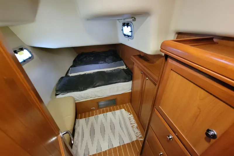 Slide: The Image of Cozy cabin interior of 2009 Hunter 49 yacht with wooden furnishings and bed. - 6