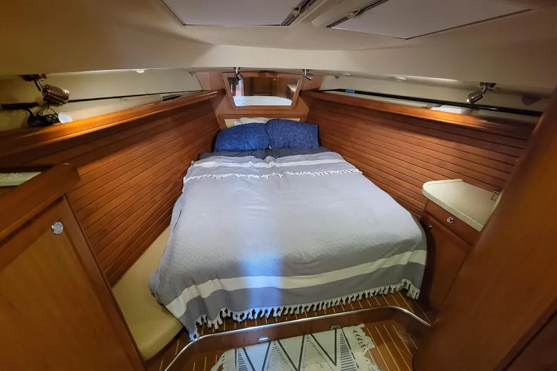Slide: The Image of Luxurious cabin interior of 2009 Hunter 49 yacht with cozy bed and wooden paneling. - 8