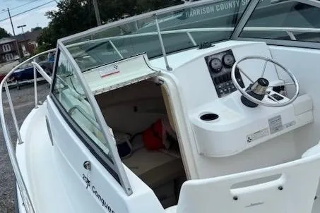 Slide: The Image of 2006 Boston Whaler 205 Conquest boat interior with steering wheel and cabin view. - 10