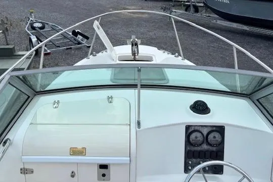 Slide: The Image of 2006 Boston Whaler 205 Conquest boat dashboard with steering wheel and gauges. - 11