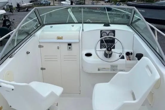 Slide: The Image of 2006 Boston Whaler 205 Conquest boat cockpit with steering wheel and seating. - 13
