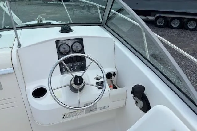Slide: The Image of 2006 Boston Whaler 205 Conquest boat helm with steering wheel and gauges. - 14