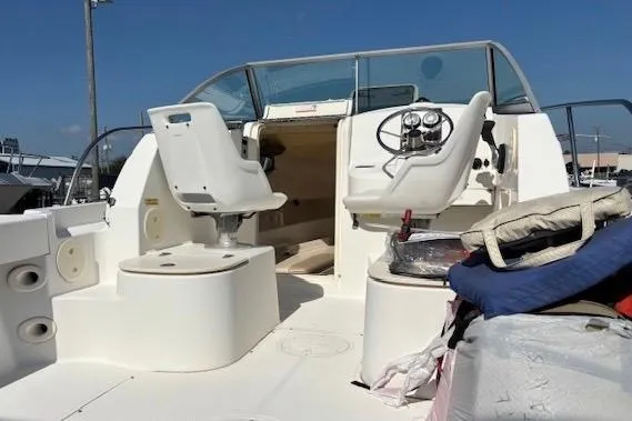 Slide: The Image of 2006 Boston Whaler 205 Conquest boat interior with helm, seating, and clear blue sky. - 5