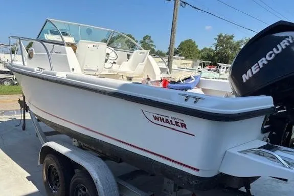 Slide: The Image of 2006 Boston Whaler 205 Conquest boat on trailer, featuring Mercury outboard motor. - 6