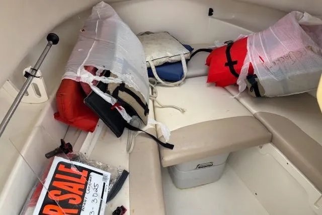 Slide: The Image of 2006 Boston Whaler 205 Conquest cabin with life jackets and a for sale sign. - 8