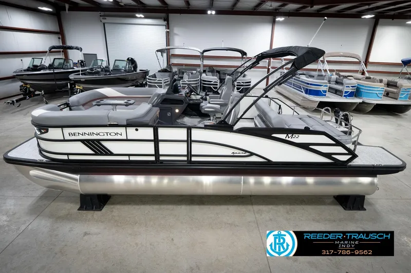 Slide: The Image of 2026 Bennington 22 MSB pontoon boat in showroom, side view. - 1