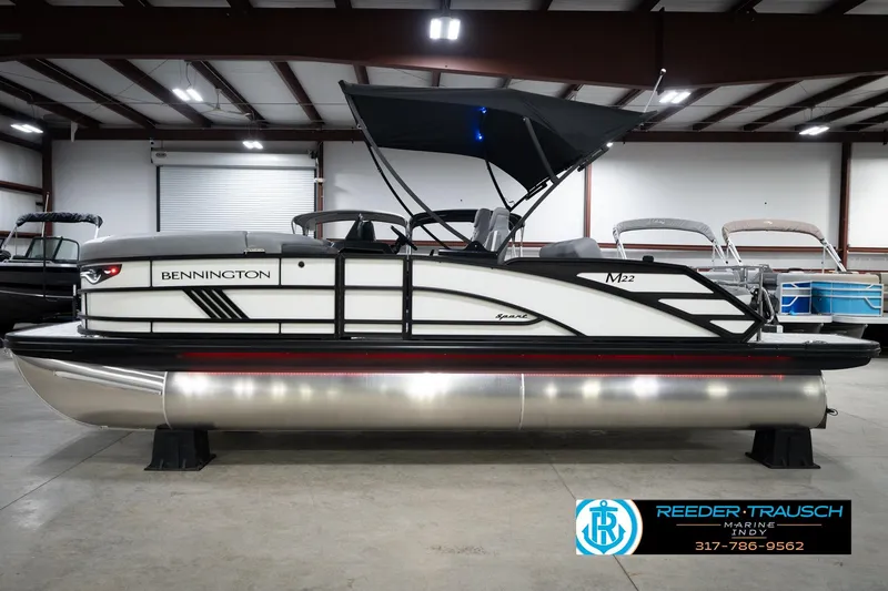 Slide: The Image of 2026 Bennington 22 MSB pontoon boat in showroom, featuring sleek design and modern amenities. - 10
