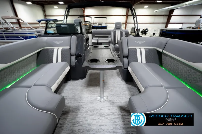 Slide: The Image of 2026 Bennington 22 MSB pontoon boat interior with gray seating and green LED lighting. - 15