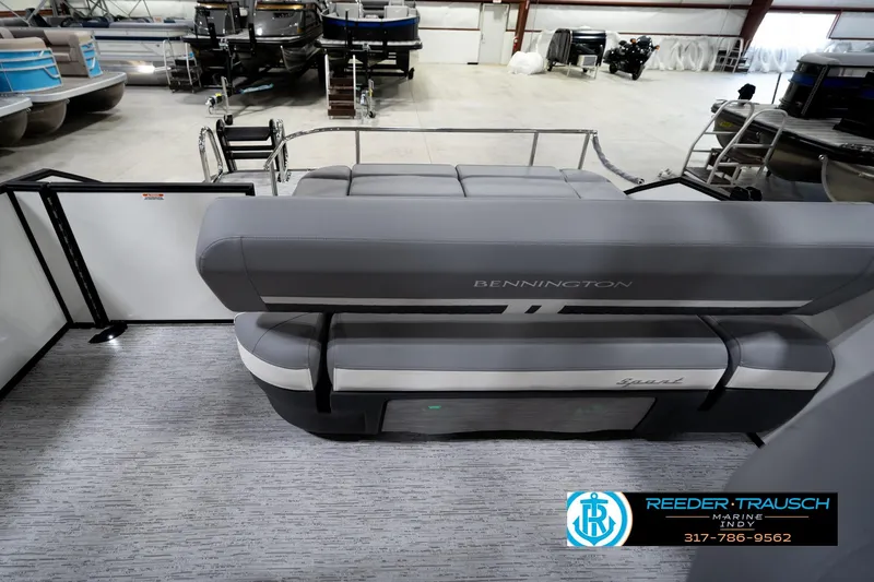Slide: The Image of 2026 Bennington 22 MSB pontoon boat interior with gray seating in showroom. - 17