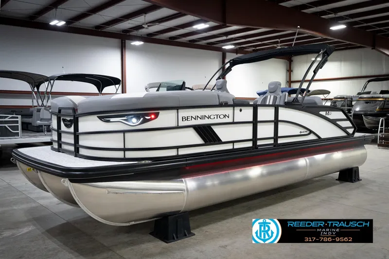 Slide: The Image of 2026 Bennington 22 MSB pontoon boat displayed indoors at Reeder-Trausch Marine. - 2
