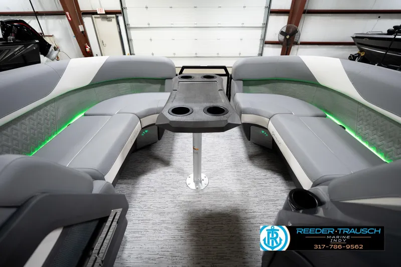 Slide: The Image of 2026 Bennington 22 MSB boat interior with gray seating and green LED lighting. - 20