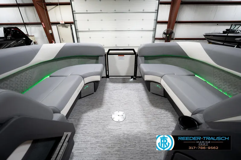 Slide: The Image of 2026 Bennington 22 MSB boat interior with gray seating and green LED lighting. - 21