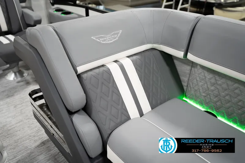 Slide: The Image of 2026 Bennington 22 MSB boat interior with gray seating and green LED lighting. - 23