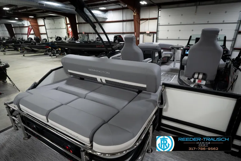 Slide: The Image of 2026 Bennington 22 MSB pontoon boat interior with gray seating in a showroom. - 26