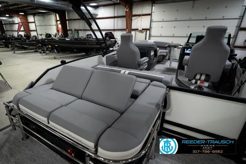 Slide: The Image of 2026 Bennington 22 MSB pontoon boat interior with gray seating in showroom. - 27