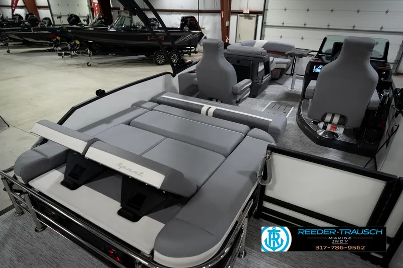 Slide: The Image of 2026 Bennington 22 MSB pontoon boat interior with gray seating in showroom. - 28