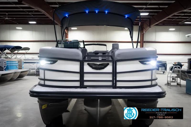 Slide: The Image of 2026 Bennington 22 MSB pontoon boat in showroom with illuminated lights. - 4