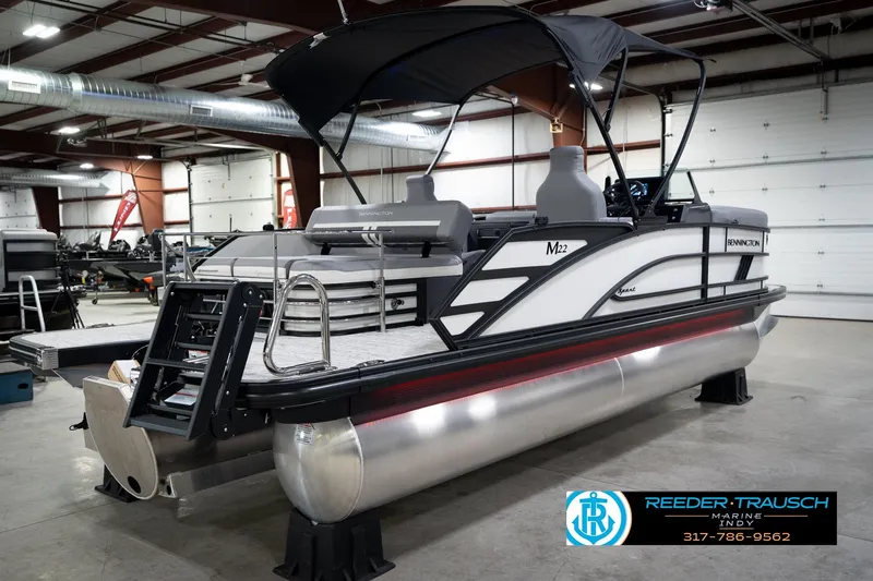 Slide: The Image of 2026 Bennington 22 MSB pontoon boat in showroom, featuring sleek design and modern amenities. - 7