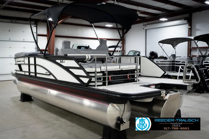 Slide: The Image of 2026 Bennington 22 MSB pontoon boat in showroom, featuring sleek design and modern amenities. - 9