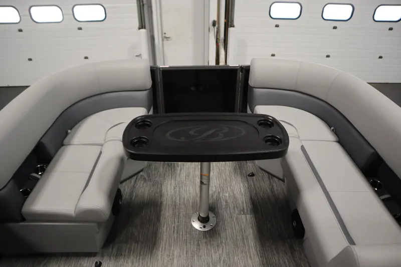 Slide: The Image of Interior of 2026 Bentley Pontoons LE 180 CR with gray seating and central table. - 10