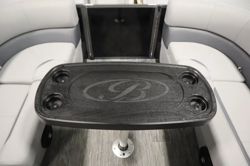Slide: The Image of 2026 Bentley Pontoons LE 180 CR interior with sleek table and cup holders. - 15