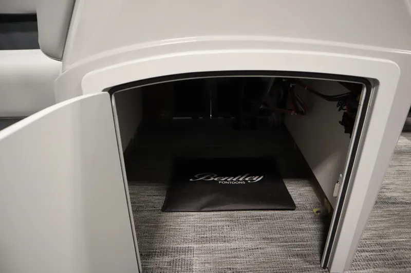 Slide: The Image of 2026 Bentley Pontoons LE 180 CR storage compartment with branded mat inside. - 17