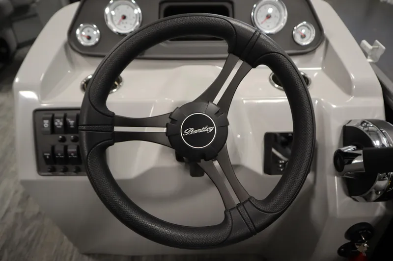 Slide: The Image of Steering wheel of 2026 Bentley Pontoons LE 180 CR with dashboard controls. - 19
