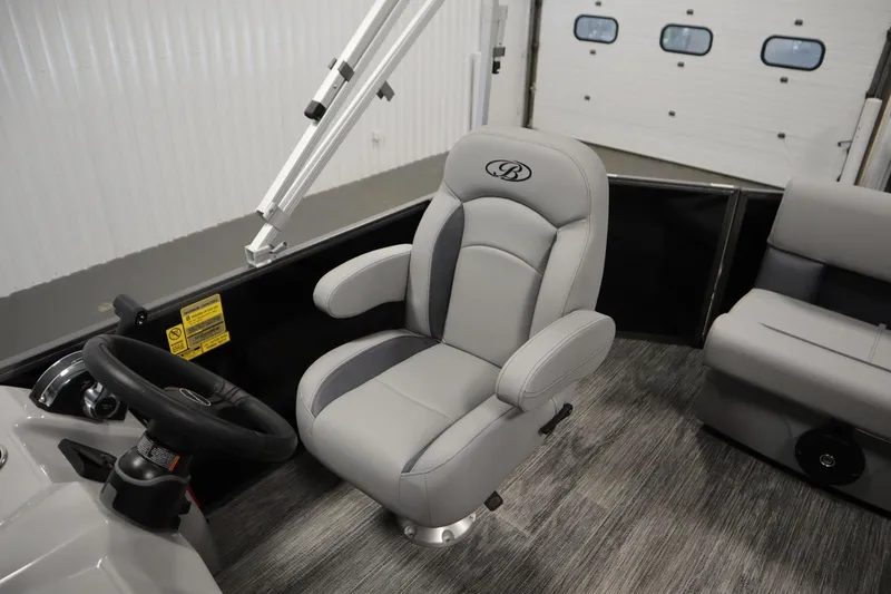 Slide: The Image of 2026 Bentley Pontoons LE 180 CR interior with gray captain's chair and steering wheel. - 24