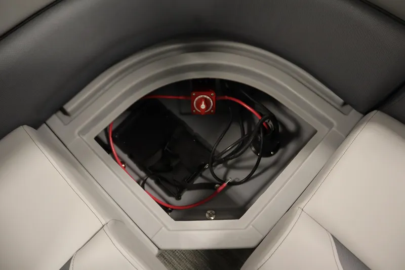 Slide: The Image of 2026 Bentley Pontoons LE 180 CR storage compartment with wiring and battery switch. - 27