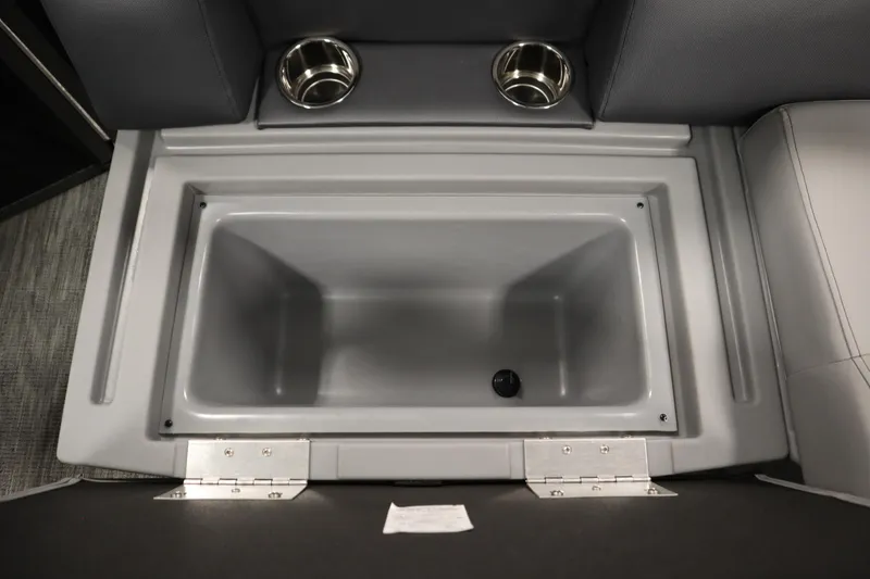 Slide: The Image of 2026 Bentley Pontoons LE 180 CR storage compartment with dual cup holders. - 28