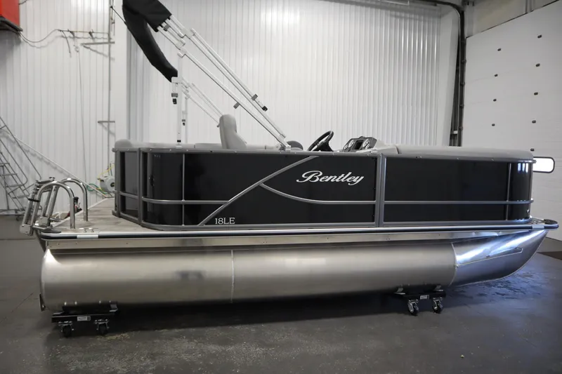 Slide: The Image of 2026 Bentley Pontoons LE 180 CR in a showroom, showcasing sleek design and modern features. - 3