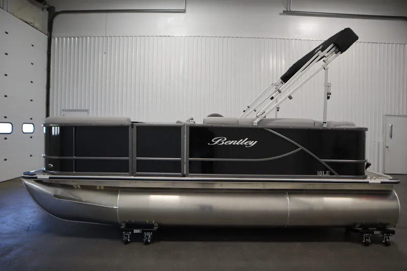 Slide: The Image of 2026 Bentley Pontoons LE 180 CR in a showroom, side view. - 7