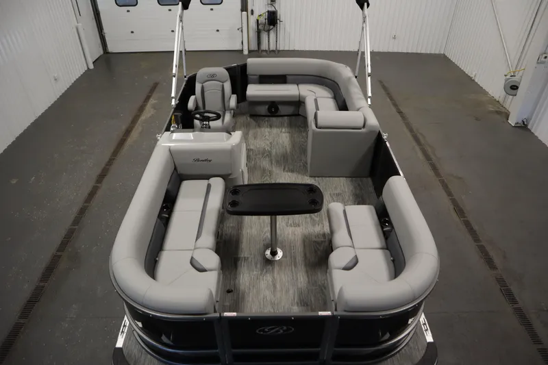 Slide: The Image of 2026 Bentley Pontoons LE 180 CR with spacious seating in a showroom. - 8