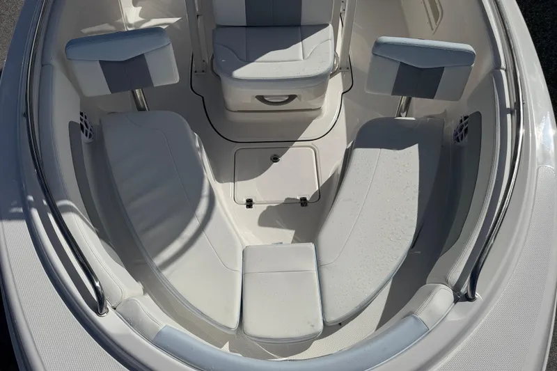 Slide: The Image of 2025 Robalo R222 Explorer boat interior with cushioned seating and storage compartments. - 10