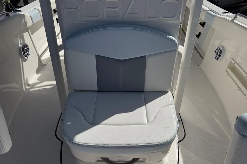 Slide: The Image of 2025 Robalo R222 Explorer boat seat with sleek design and water droplets. - 12