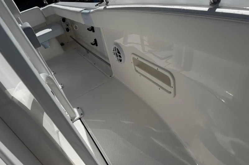 Slide: The Image of 2025 Robalo R222 Explorer boat interior, featuring sleek white deck and seating. - 13