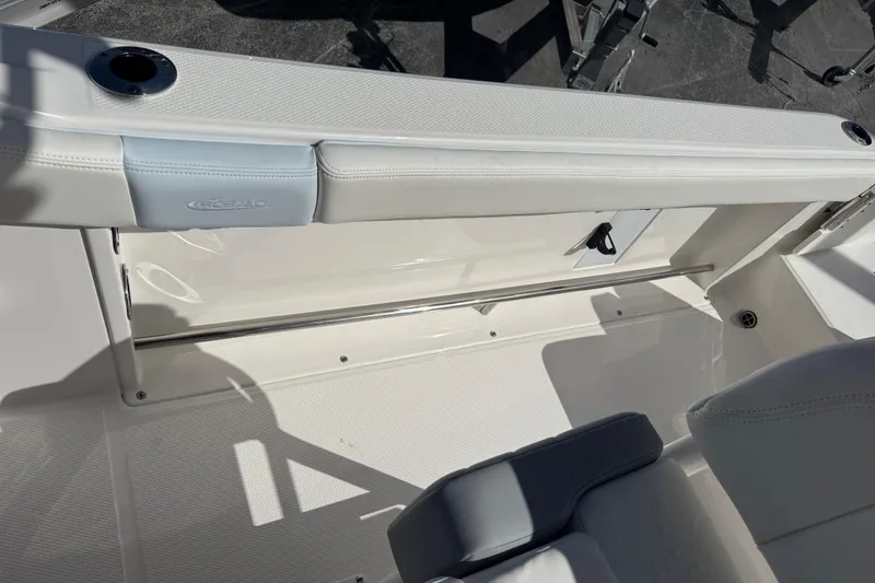 Slide: The Image of 2025 Robalo R222 Explorer boat interior with white seating and stainless steel rail. - 18